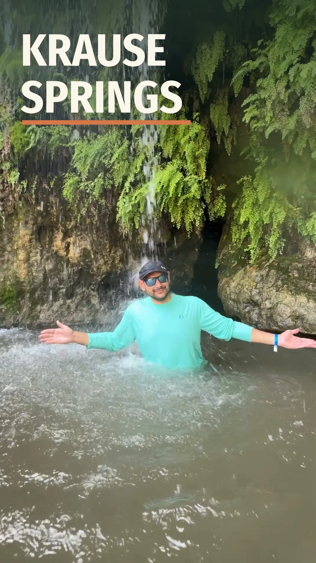 Jose standing under the Krause Springs waterfall